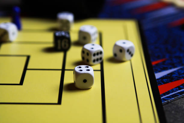 istock Close up of dices on yellow game board 1164104604