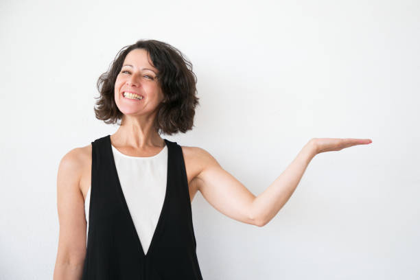 istock Joyful excited woman in casual presenting information 1164107080