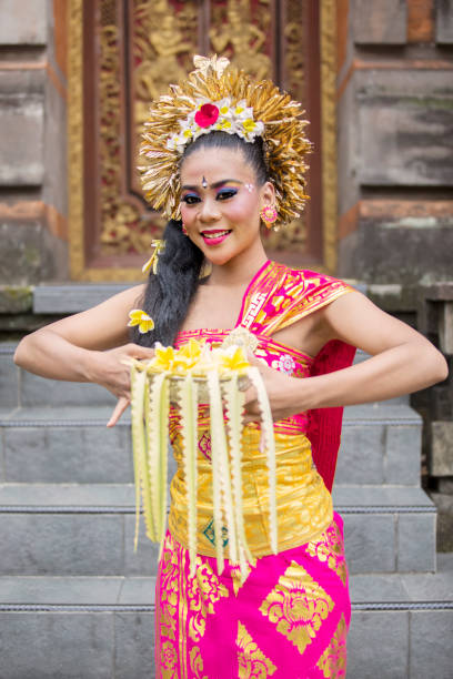 istock Beautiful balinese dancer with frangipani flowers 1164108467