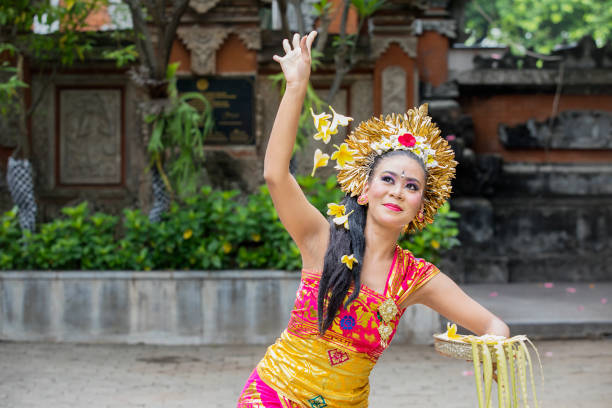istock Beautiful Pendet dancer throws frangipani flowers 1164108499