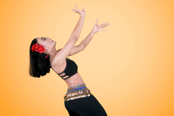 istock Beautiful woman doing belly dance on studio 1164108523