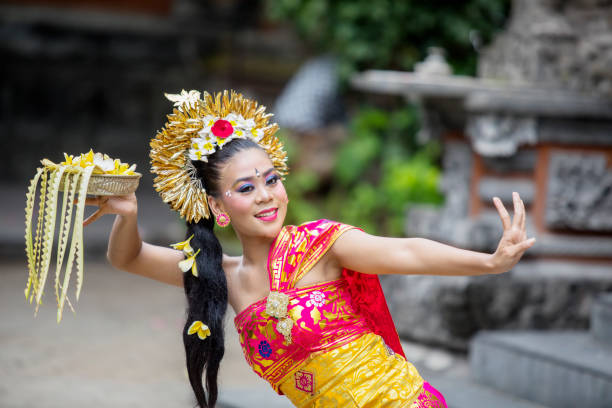 istock Young balinese pendet dancer dancing in temple 1164108588