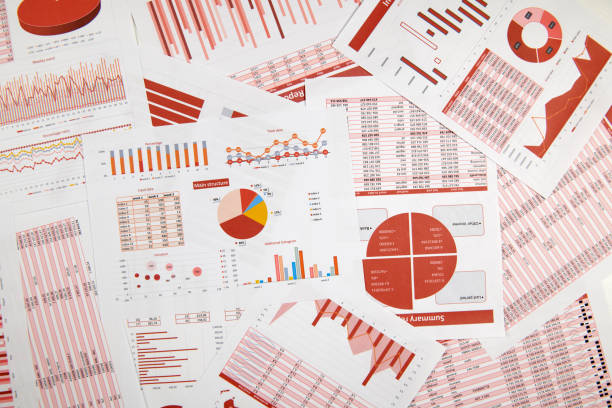 istock Business reports, data tables and charts - directly above view of office table workspace. 1164111525