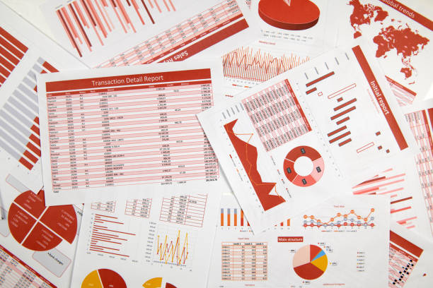 istock Business reports, data tables and charts - directly above view of office table workspace. 1164112669