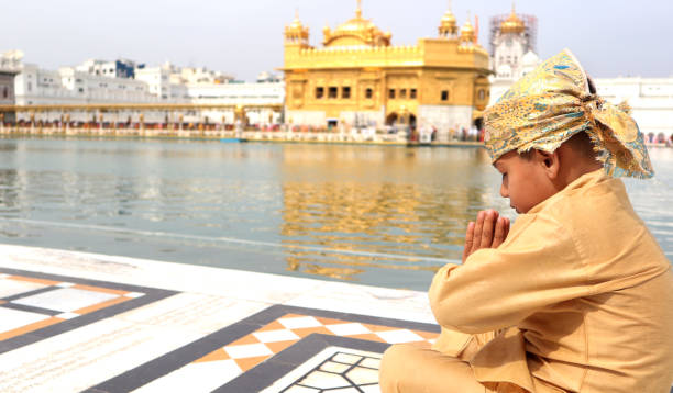istock Boy praying in Golden temple in Amritsar, India 1164114604