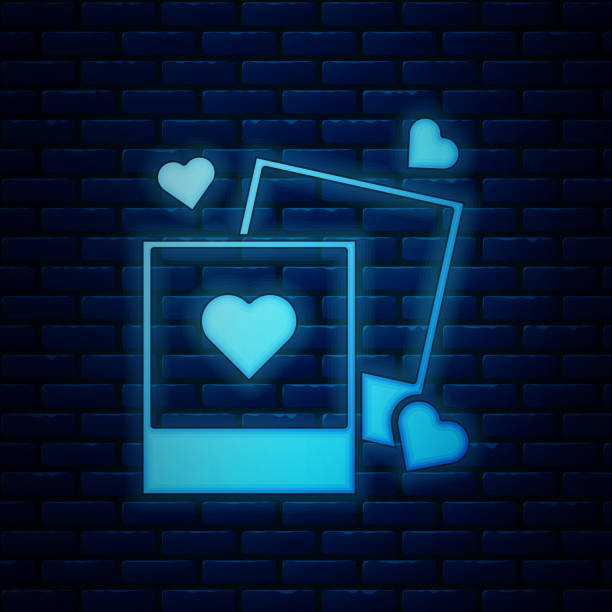 istock Glowing neon Two blanks photo frames and hearts icon isolated on brick wall background. Valentines Day symbol.  Vector Illustration 1164116825