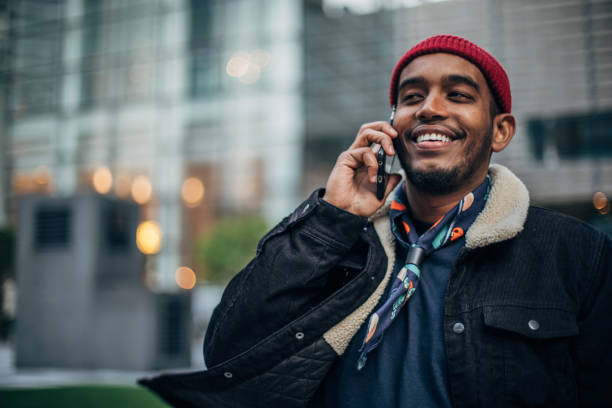 istock Modern man talking on mobile in city 1164116977