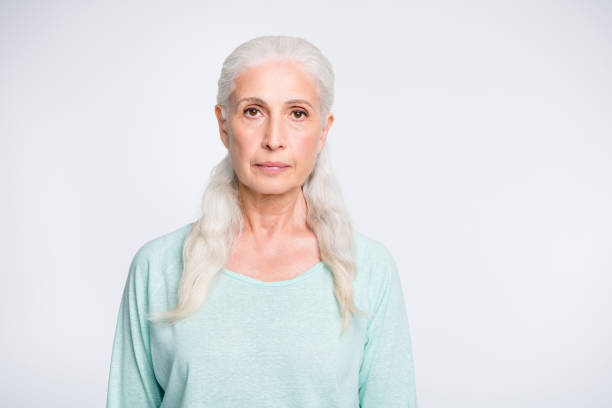 istock Portrait of concentrated charming woman looking wearing teal pullover isolated over white background 1164117241