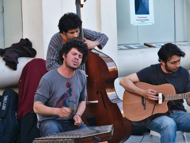 Istanbul, Turkey - 05/25/2010: Street musicians performing in Istanbul. Young man singing and plays santur (cimbalom).