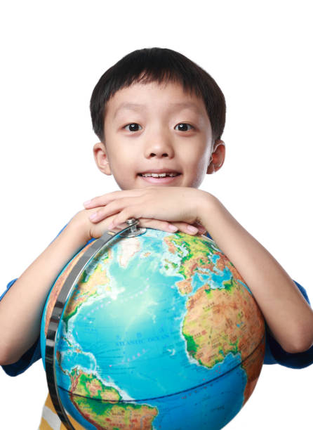 istock Young asian boy with globe against white background 1164121157