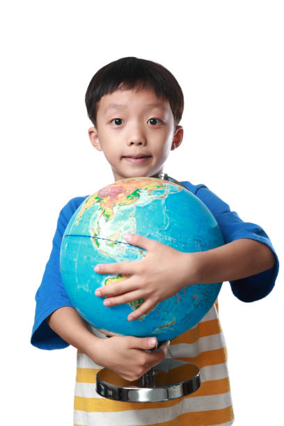istock Young asian boy with globe against white background 1164121165
