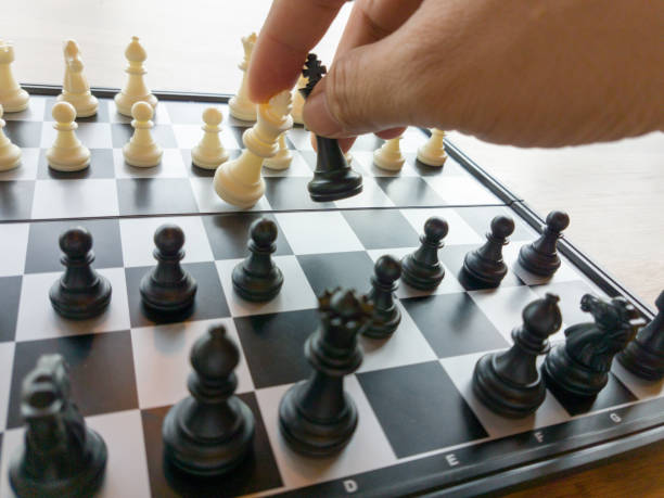 istock male's hand moving chess figure competition success play 1164122617