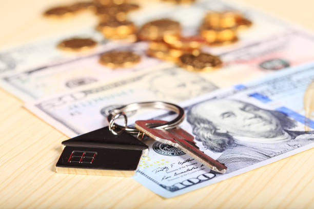 istock House model and the key, the dollar and gold abacus 1164122834