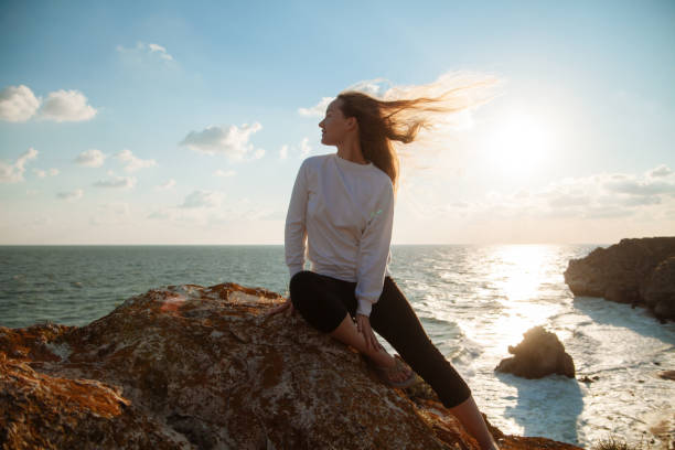 istock Girl on the sea coast 1164129763