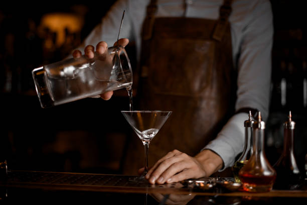 istock Bartender pouring an alcohol cocktail from jar 1164130685