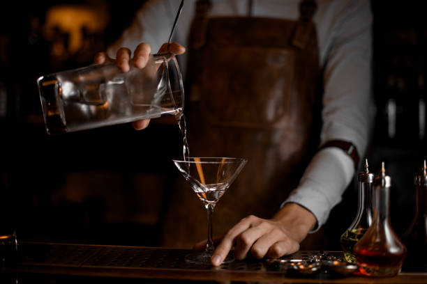 istock Bartender pours an alcohol cocktail from jar 1164130818