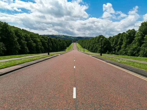 istock Long Road going  down in park with trees around Stromont, Belfast Northern Ireland 1164142603