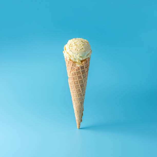 istock Ice cream scoop with ice cream cone on bright background. Minimal summer concept. 1164143270