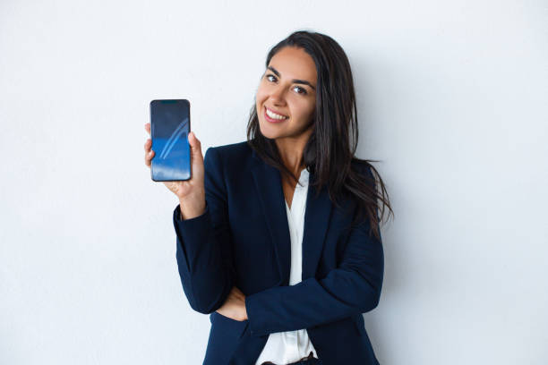 Happy young woman showing smartphone