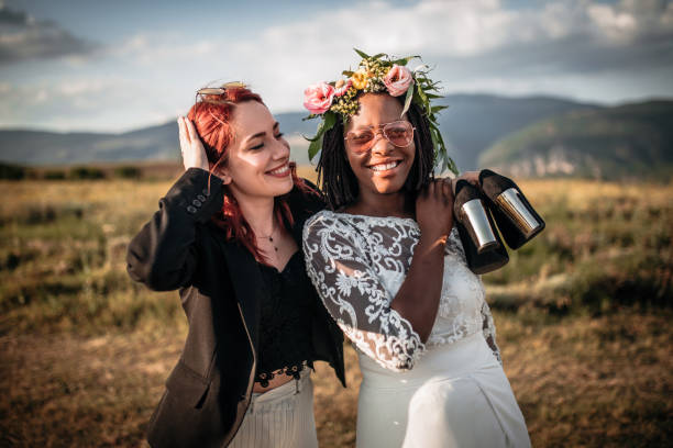 Two beautiful brides dancing  on the green field of the golf club