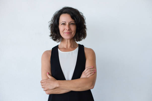 istock Cheerful middle aged woman with curly hair 1164149342