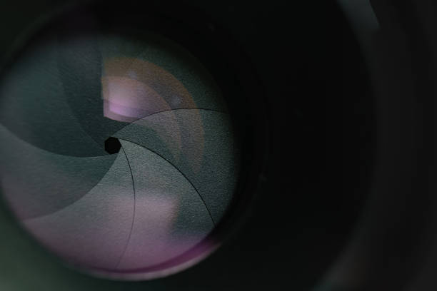 istock Beautiful camera lens aperture with multi colored reflection on a glass. Macro view  background. 1164149444