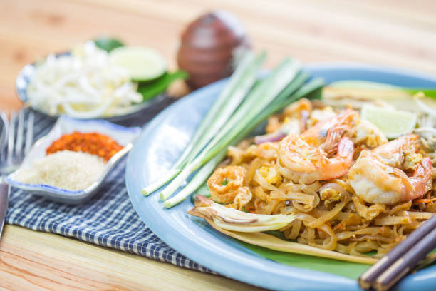 istock Pad Thai - Rice noodles with shrimps and vegetables close-up on the table. 1164149607