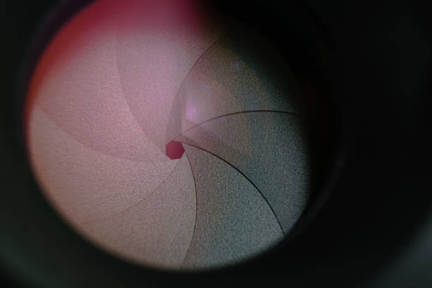 istock Beautiful camera lens aperture with multi colored reflection on a glass. Macro view  background. 1164149833