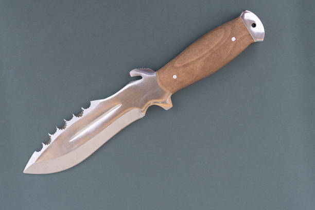 istock Brown Army knife on a gray background. knife close-up. 1164149991