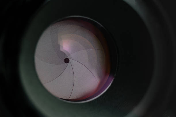 istock Beautiful camera lens aperture with multi colored reflection on a glass. Macro view  background. 1164151619