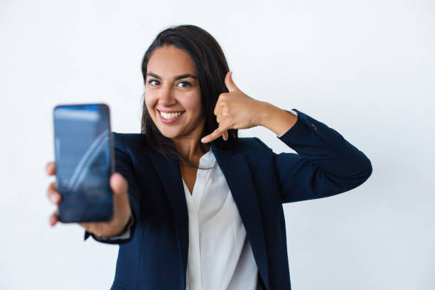 istock Cheerful young woman showing smartphone 1164154277