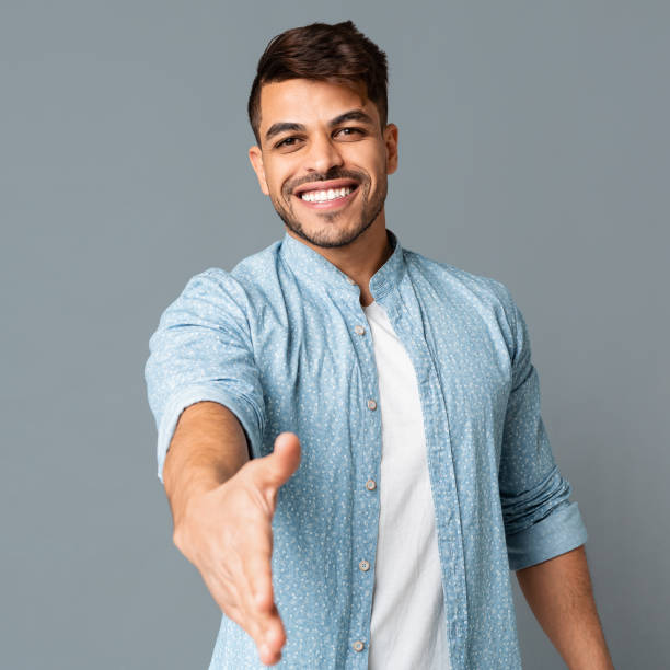 istock Young Arab Man Stretching His Hand For Greeting 1164157095