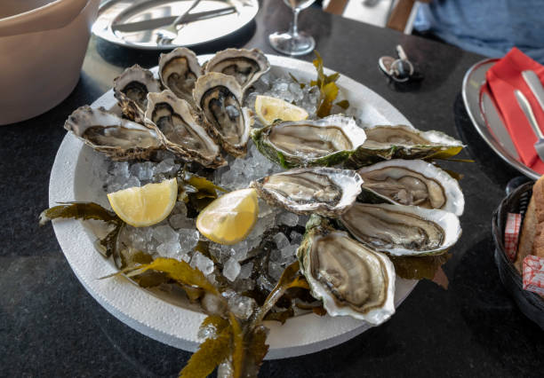 istock Top view on Fresh oyster with lemon on a plate. 1164161769