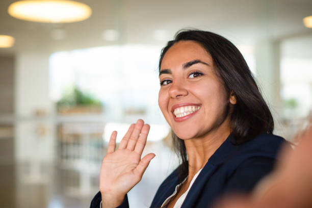 istock Happy young woman waving hand 1164164459