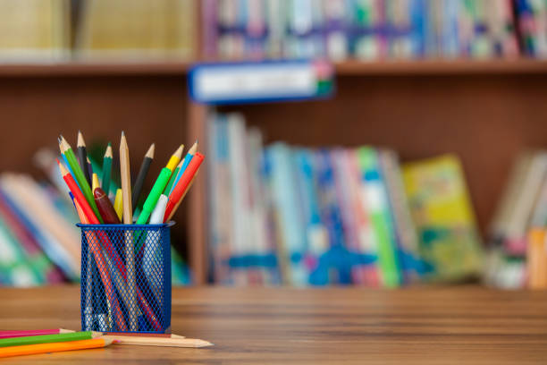 multicolored pens in jar on table copy space
