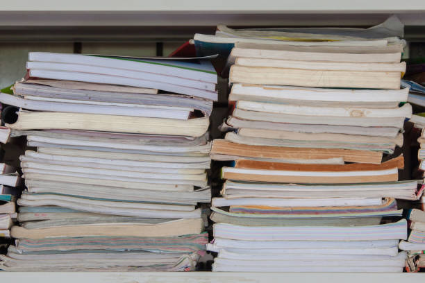 istock Book stack in the library room and blurred bookshelf for business and education background 1164165754