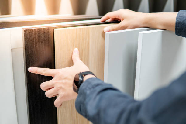 Male hand choosing cabinet or countertop materials Male hand choosing cabinet panel materials or countertops for built-in furniture design. Shopping furniture and decoration. Home improvement concept oak wood material photos stock pictures, royalty-free photos & images