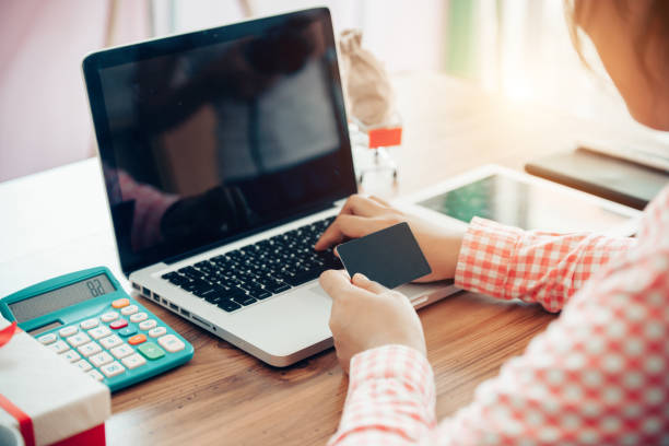 istock Hands holding credit card and using laptop. Online shopping 1164165912