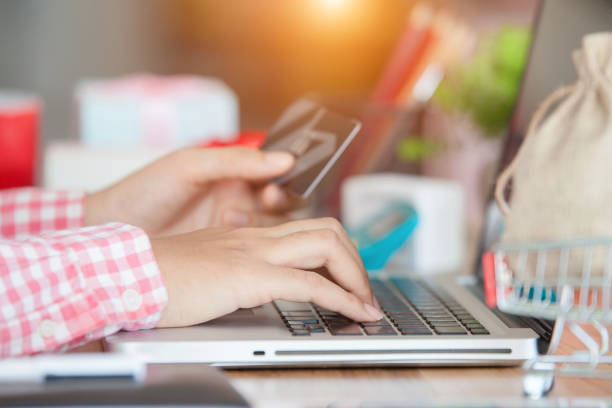 istock Hands holding credit card and using laptop. Online shopping 1164166918
