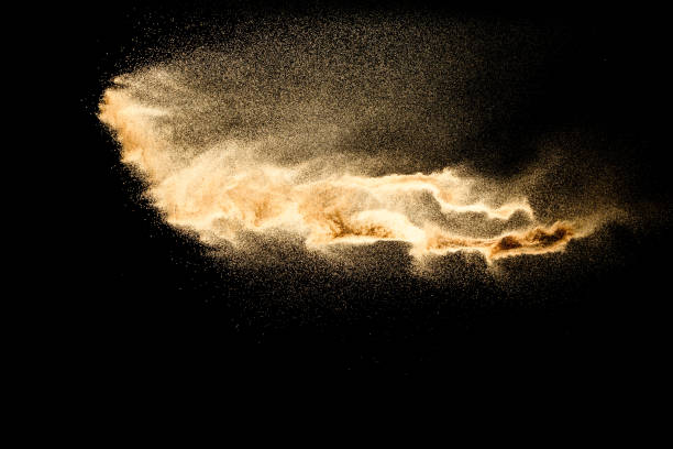 istock Abstract sand cloud.Golden colored sand splash agianst dark background.Yellow sand fly wave in the air. Sand explode on black background ,throwing freeze stop motion concept. 1164167336