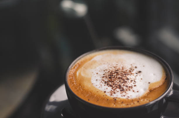 istock close up modern hot black coffee the cappuccino on dark background with coffee bubble foam pattern and texture in black cup looking and feel so delicious on glasses table in coffee shop. 1164170030