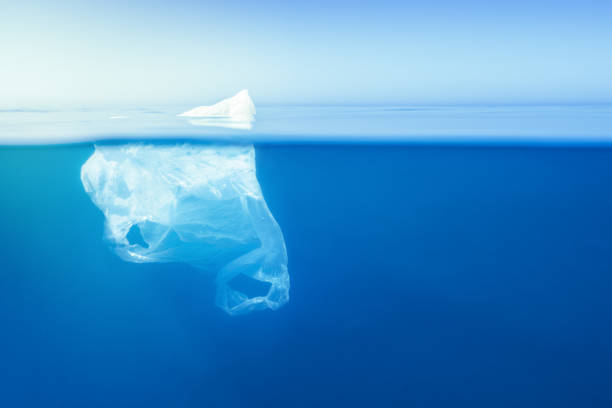 istock plastic bag floating at water, iceberg metaphor 1164172642