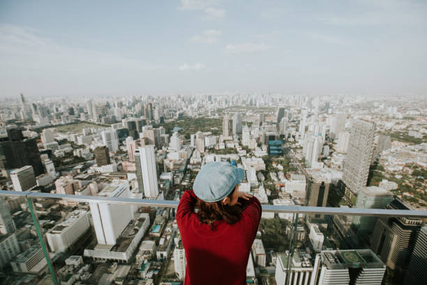 istock Loneliness woman with cityscape view 1164172729