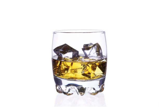 istock A glass of whiskey with ice cubes on a white background. 1164174538