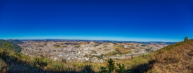 Panoramic photo of the city Poços de Caldas, Minas Gerais - Brazil, from the top of the mountain with blue sky on sunny day