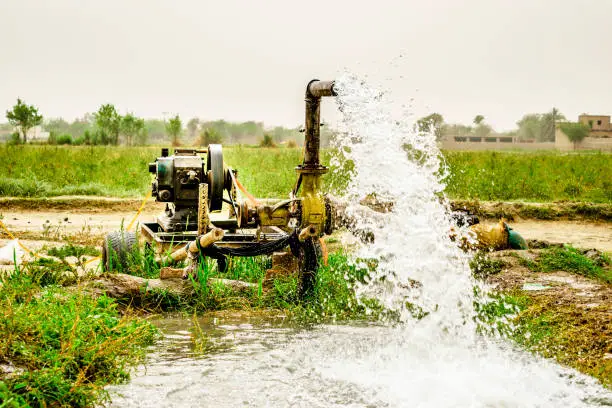 high pressure crystal bluish sweet water flushing out of an agriculture industrial tube well in fields