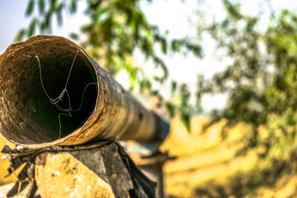 istock an old and rusty abandoned water supply dried pipe and spider web is on it's front of it in the sunny day 1164176761