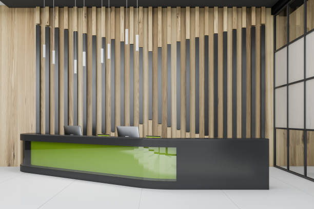istock Green reception desk in wooden office 1164177568