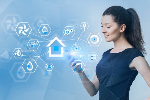 istock Smiling woman with phone, smart home interface 1164179431