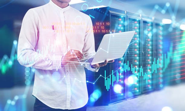 istock Man in server room, graphs and stock market 1164179435